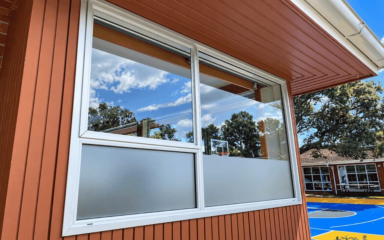 Sunlit commercial interior with furniture and large windows suitable for UV protection film