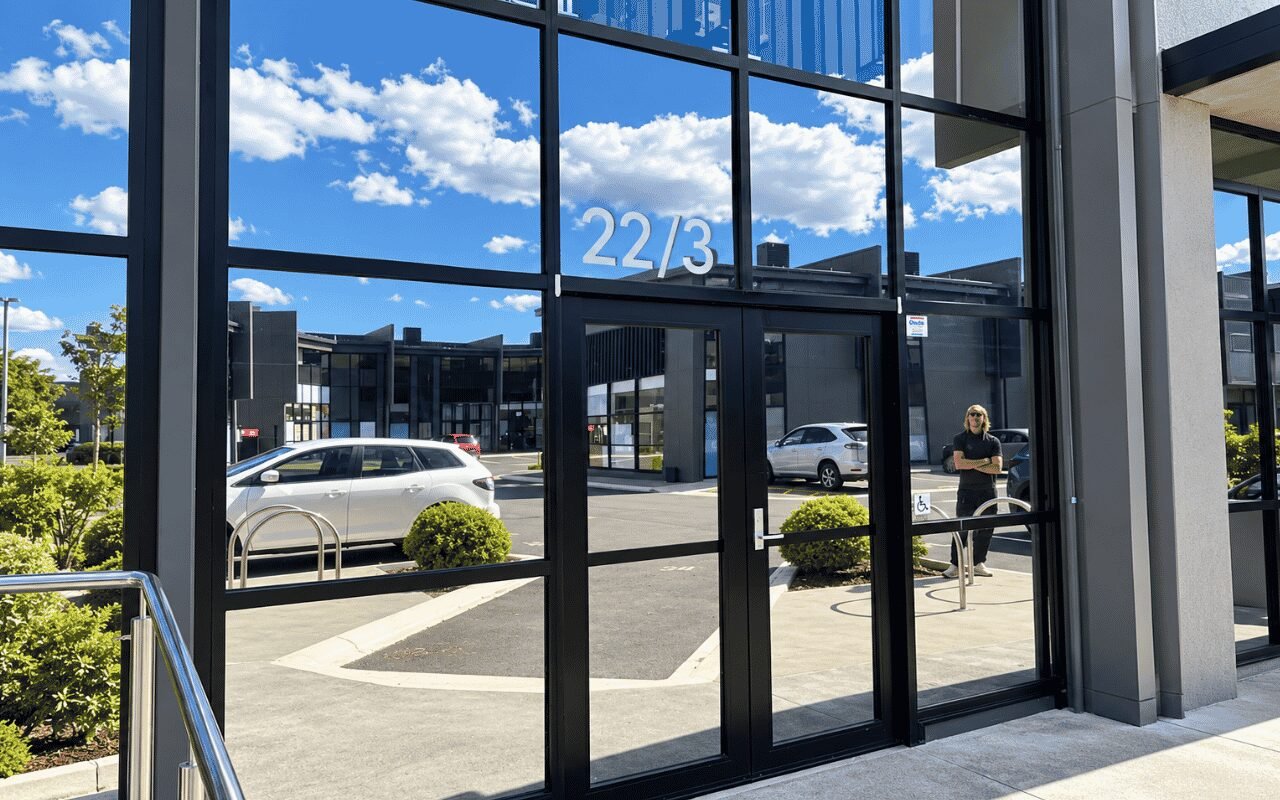 Commercial office glazing being measured for a window tinting quotation